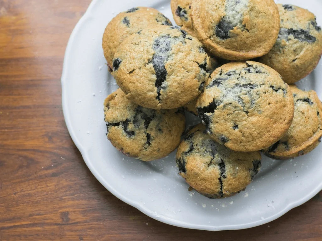 Vegan-blueberry-muffins-on-a-white-plate-with-moist-and-fluffy-texture