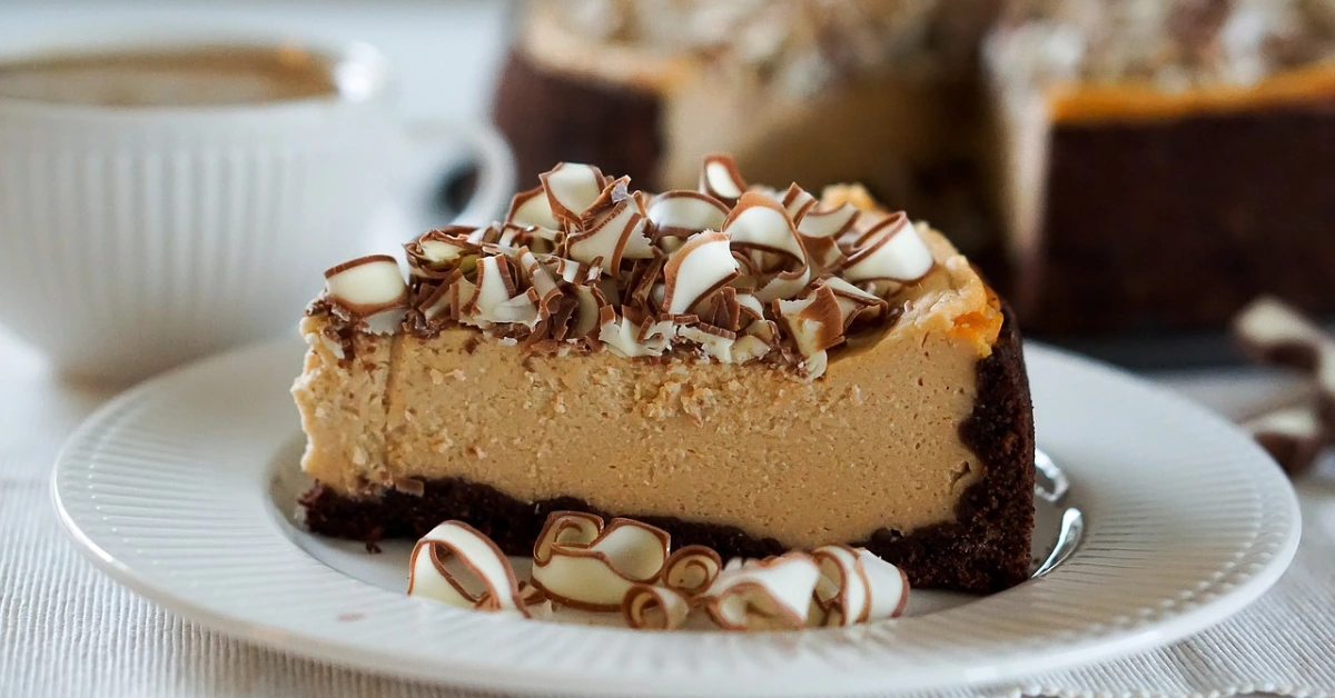 slice-of-chocolate-cheesecake-with-swirl-topping-on-white-plate